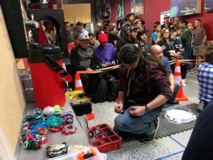beyblade tournament area with crowd in the background