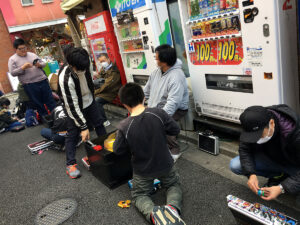 beyblade players at tournament in alleyway