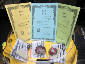 certificates and prizes for beyblade tournament sitting inside stadium