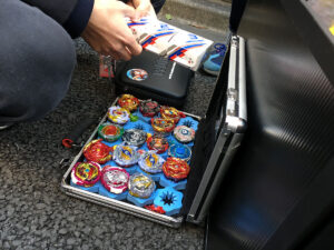 opened attache case filled with beyblades