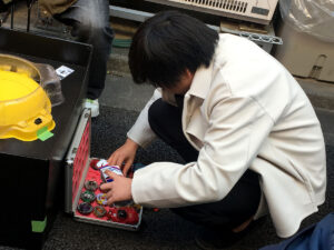 player choosing beyblades from open attache case