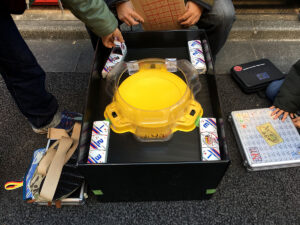 yellow beyblade stadium surrounded by four 3on3 deck boxes