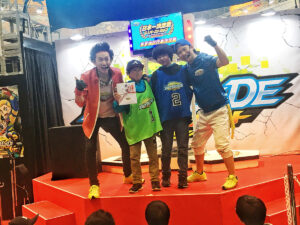 beyblade burst grade 1 tournament winners on stage with judges