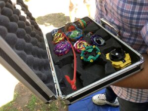 open attache case filled with beyblades and launchers