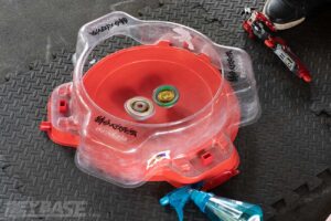 two beyblades battling in red stadium