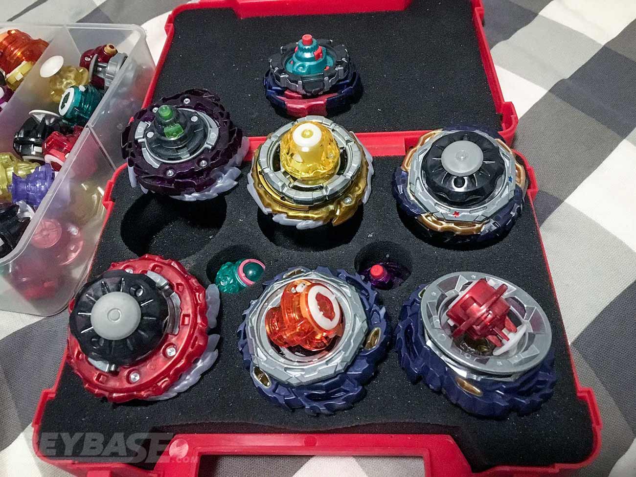 seven beyblade burst combos resting on top of foam inside red case