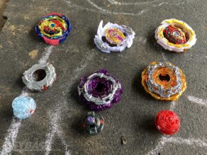 three disassembled beyblade combos