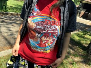 person wearing red beyblade tyson tshirt
