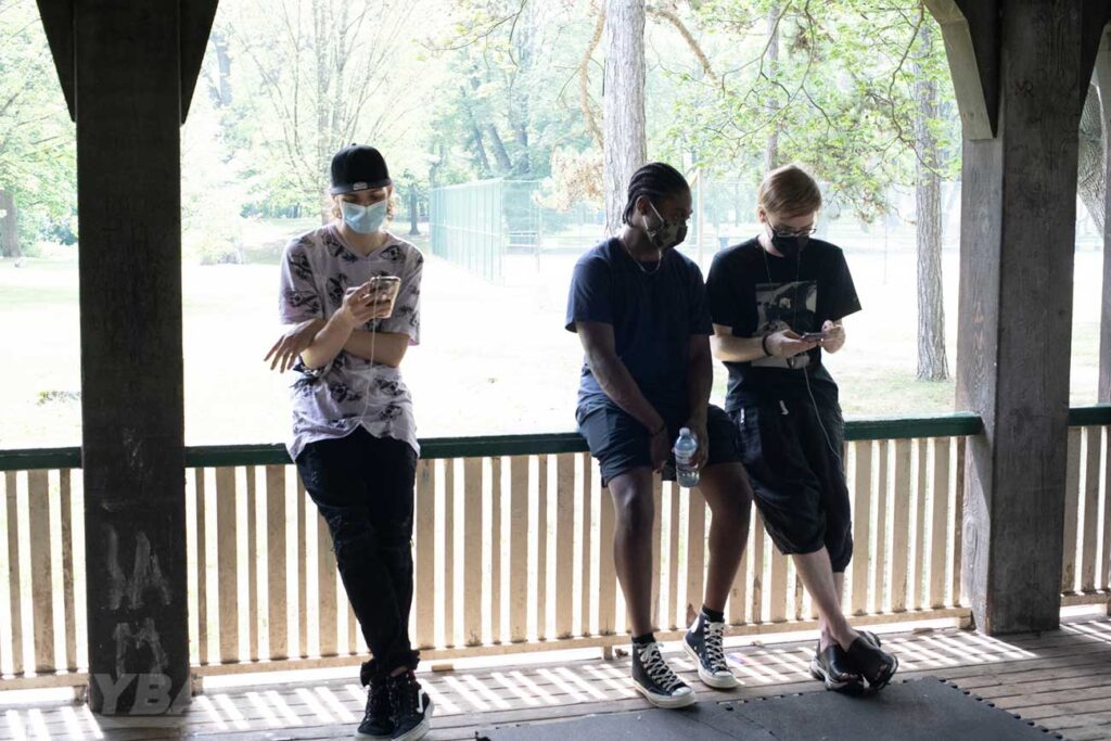 1234beyblade, justin tc, and kei sitting on railing of shelter