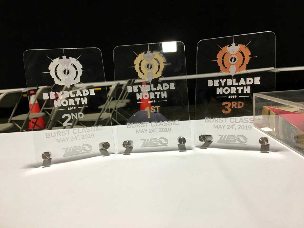 clear acrylic trophies with beyblade north logo and tournament information etched on them