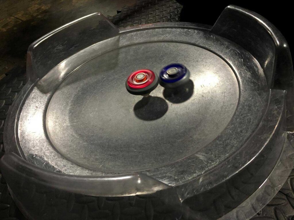 two metal fight beyblades battling in attack stadium