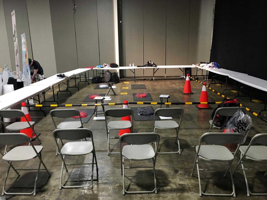 rows of chairs lined up in front of pylons and barriers